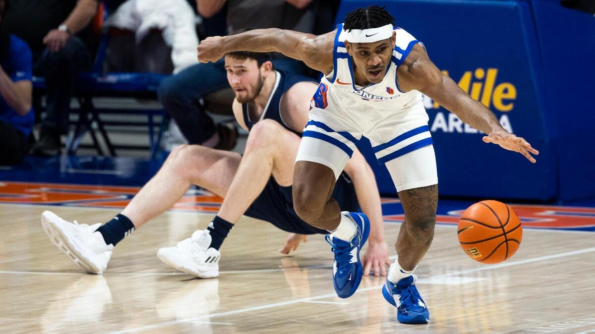 Boise State guard Chibuzo Agbo steals the ball from Nevada center Will Baker in the second half Jan. 17 at ExtraMile Arena in Boise.