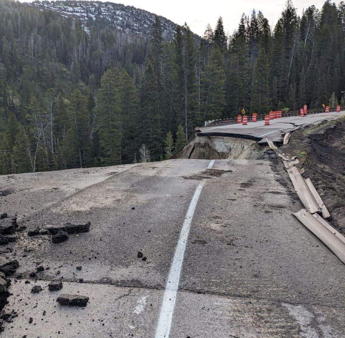 A driver’s view shows the Wyoming State Highway 22 failure at milepost 12.8 where the highway drops into an abyss.