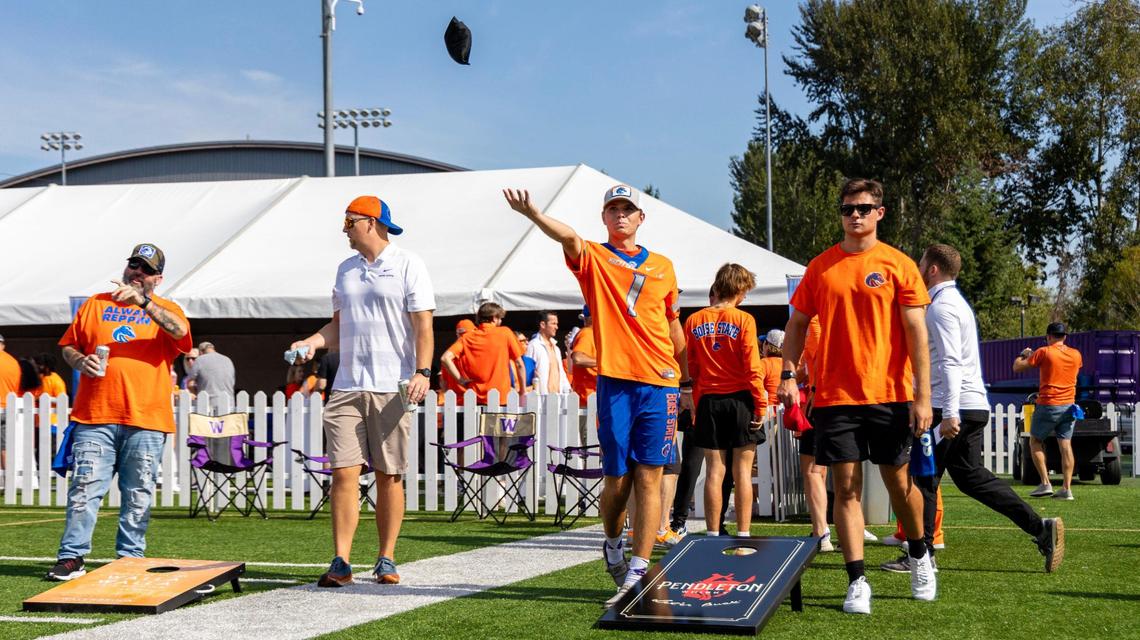Boise State students Dom Iglesias and Parker Green play cornhole at a tailgate party at the University of Washington in Seattle, Saturday, Sept. 2, 2023.