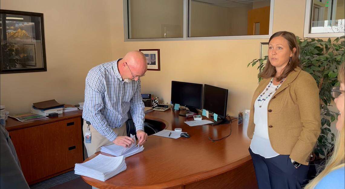Ed Kopp, Boise’s supervisor of licenses and permits, counts signed petitions submitted by the Boise Parks Association. One of the group’s directors, Aimee Russell, looks on.