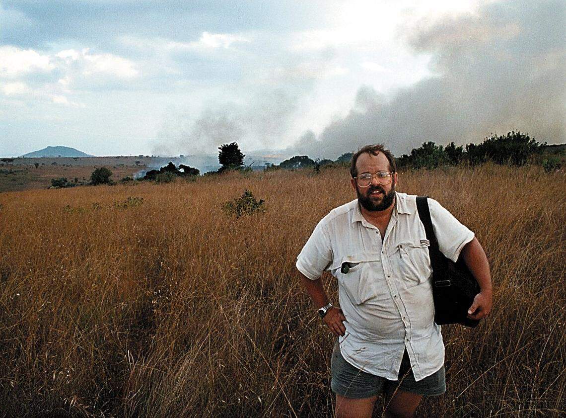 Writer Rocky Barker stands in front of a fire started by poachers in Nyika National Park in Malawi.