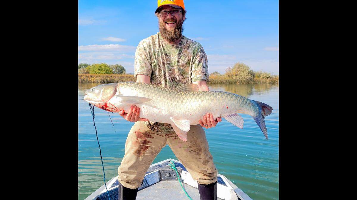 Meridian angler Cris Endicott poses with a state record rod-and-reel grass carp, which weighed 46.7 pounds and measured 50 inches long. Endicott caught the fish on the Snake River on Oct. 10.
