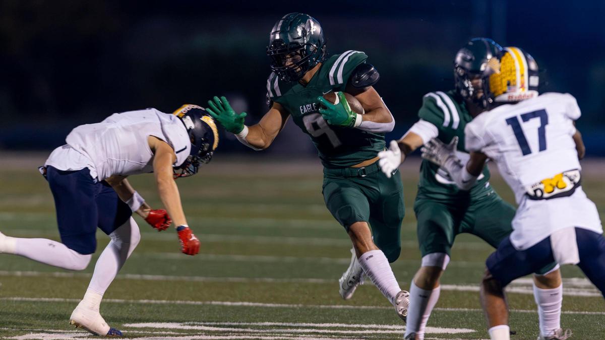 Eagle tight end Seth Brock tries to fight off a tackle from Meridian’s Cole Jones in the 5A SIC title game on Oct. 20.