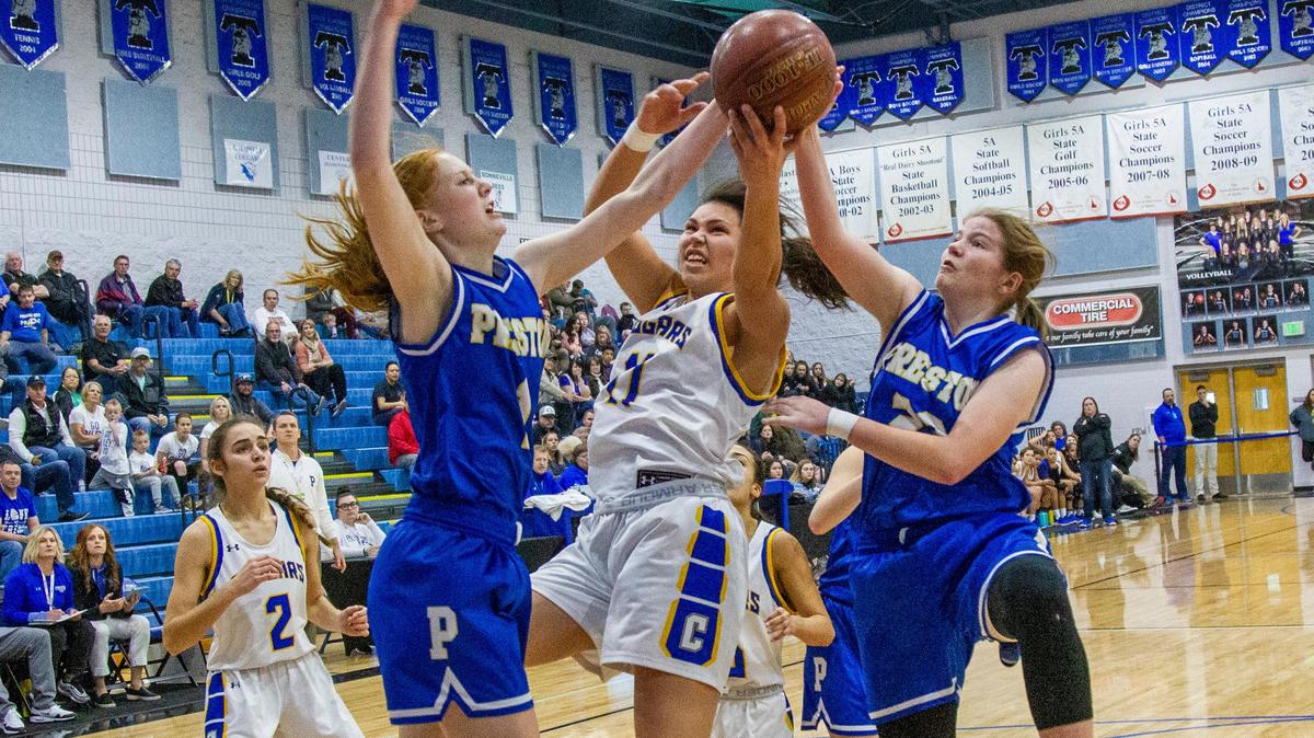 Caldwell’s Courtney Williams is fouled under the basket under pressure from Preston’s Hailey Meek, left, and Cassee Pugmire. Caldwell beat Preston 49-45 in the first round of the 4A girls state basketball championships at Timberline High School on Thursday, Feb. 20, 2020.