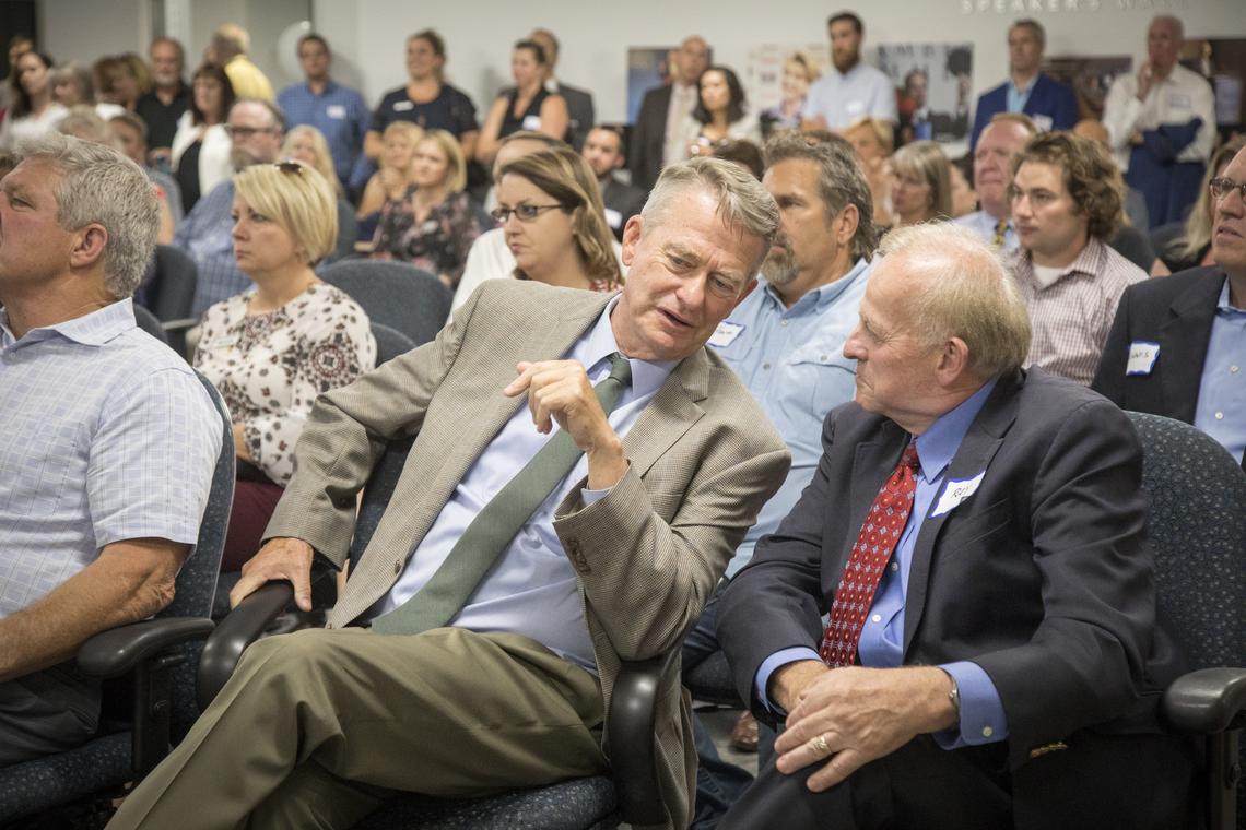 Lt. Gov. Brad Little talks with Ray Stark, senior vice-president of the Boise Metro Chamber, at the ribbon-cutting of a new building at 11th and Front streets.