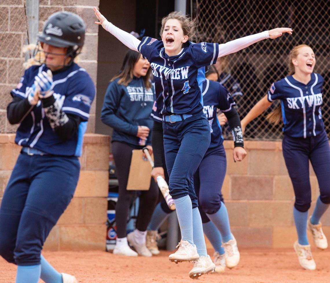 Skyview players, including Reagan Graham (4), step out of the dugout to celebrate a home run Friday in the 5A state tournament at Mountain View High School.