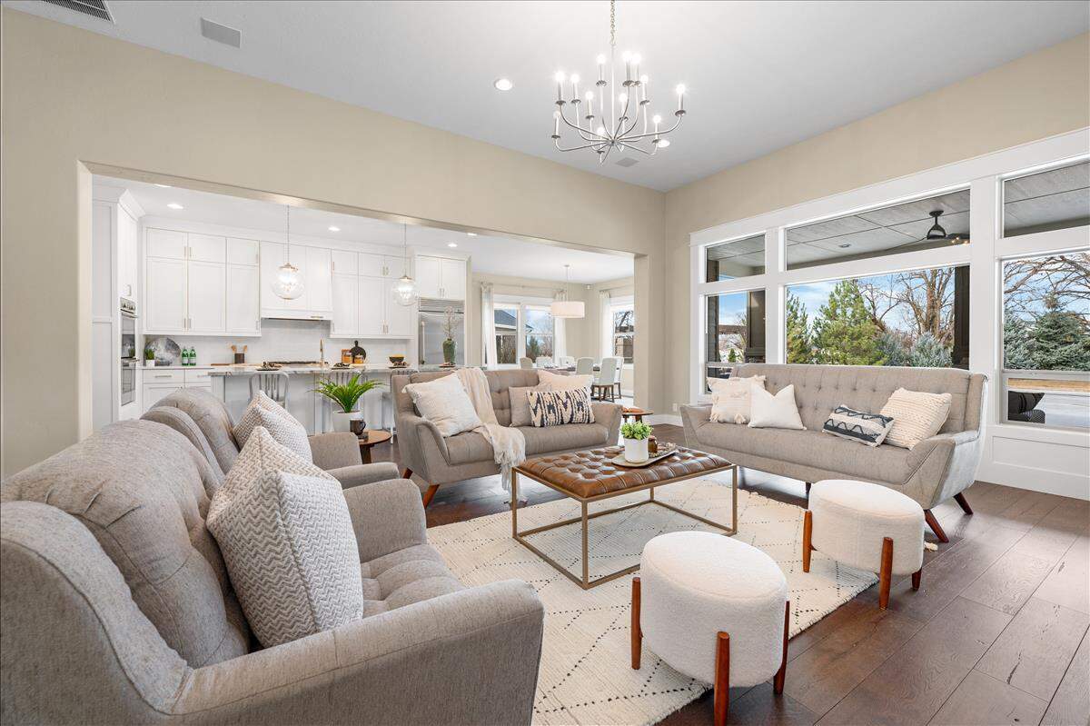 The kitchen of the property includes double ovens, a built-in fridge, a six-burner gas cooktop, a large island with a sink, and an oversized eating area.