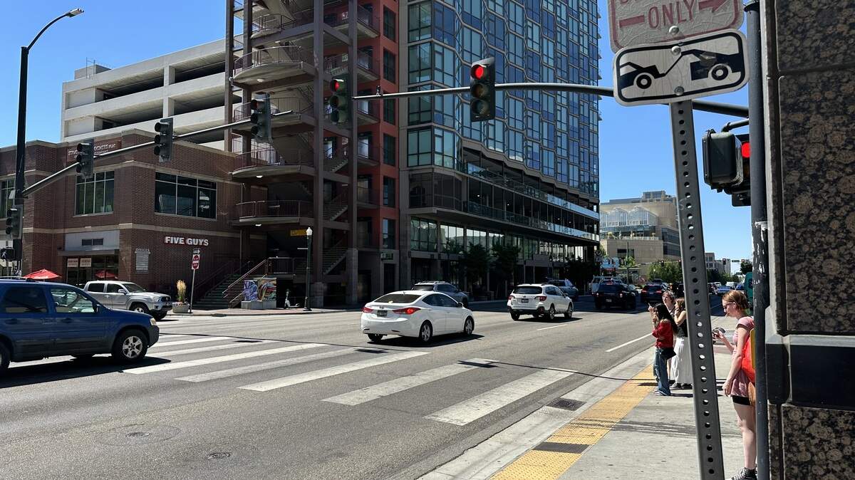 With pedestrians getting ready to cross Front Street at 8th Street in downtown Boise, several cars run the red light Tuesday, Aug. 5, 2025.