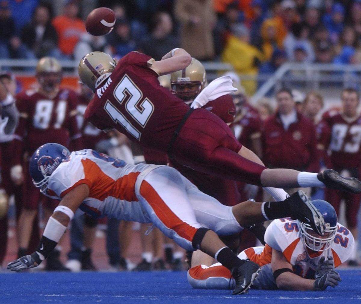 Boston College quarterback Matt Ryan fumbles after being hit by Boise State defensive tackle Alex Guerrero and linebacker Korey Hall. The Eagles recovered the fumble, and Ryan was named the Eagles´ MPC Computers Bowl MVP.