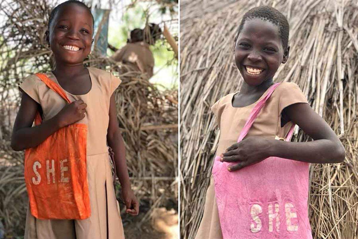 Two girls in Togo holding bags and wearing school uniforms provided by Idaho Falls native Payton McGriff’s organization.