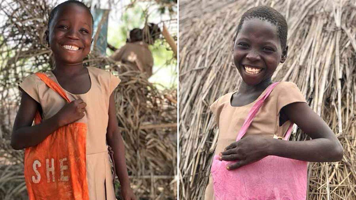 Two girls in Togo holding bags and wearing school uniforms provided by Idaho Falls native Payton McGriff’s organization.
