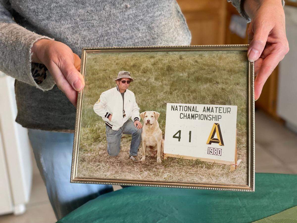 Liliia Mauney holds a picture of her husband, James Mauney, from 1980 in their Juliaetta home in March 2024. James Mauney, 83, was killed after he disappeared on a dog walk in Juliaetta. Police say two men involved in a Boise prison escape are suspects in his death. 