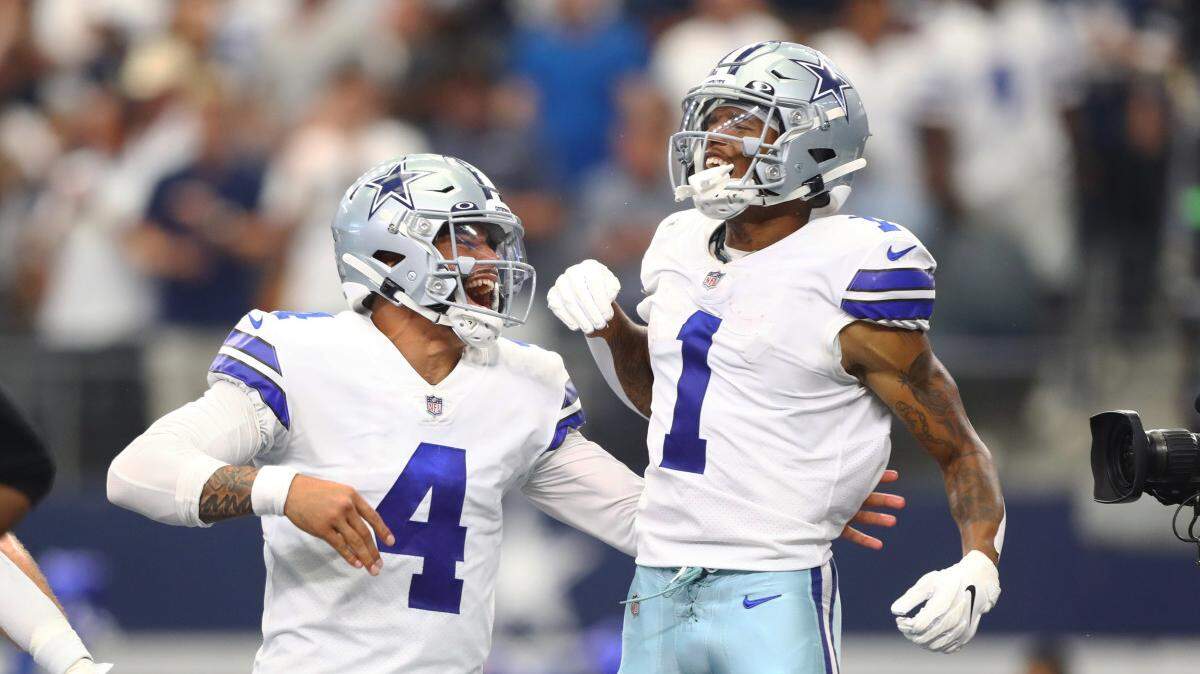 Former Boise State wide receiver Cedrick Wilson Jr. (1) celebrates with Dallas Cowboys quarterback Dak Prescott during a game last season. Wilson has agreed to a three-year deal with the Miami Dolphins.