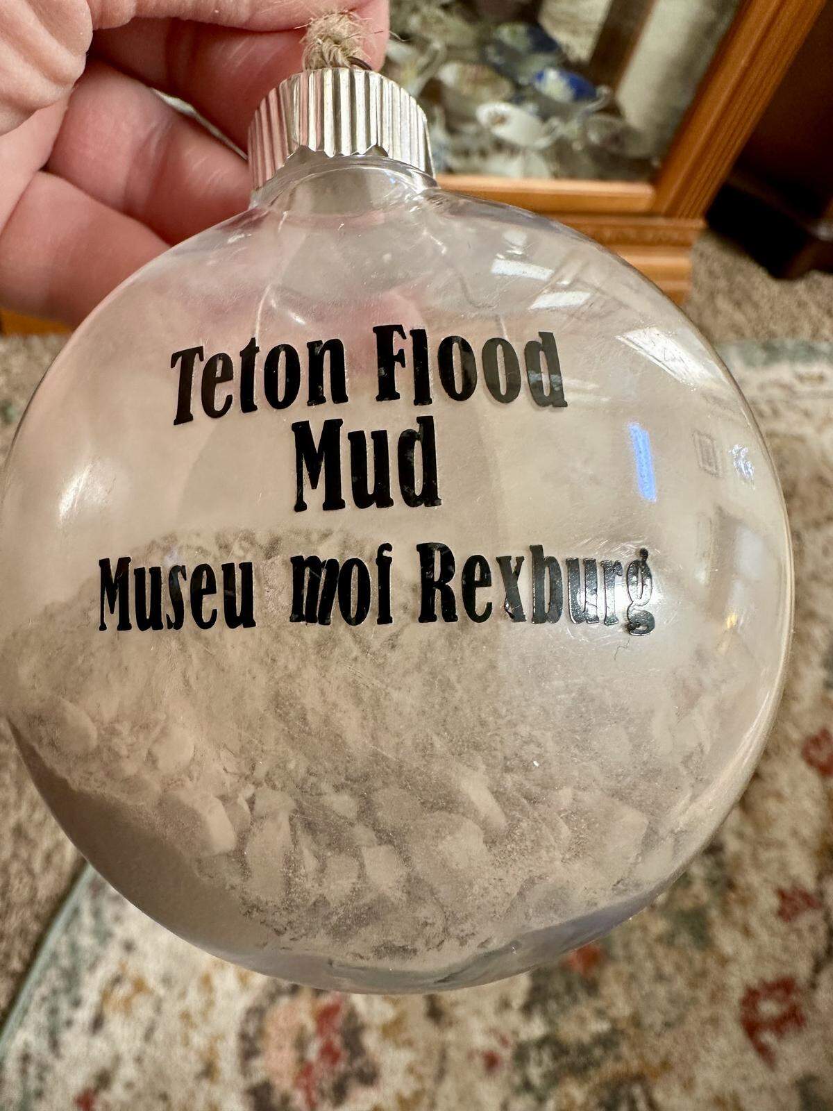 Anita Knapp has a Christmas tree ornament containing remnants of what they called “flood mud,” which coated everything in sight after the Teton Dam collapse on June 5, 1976.