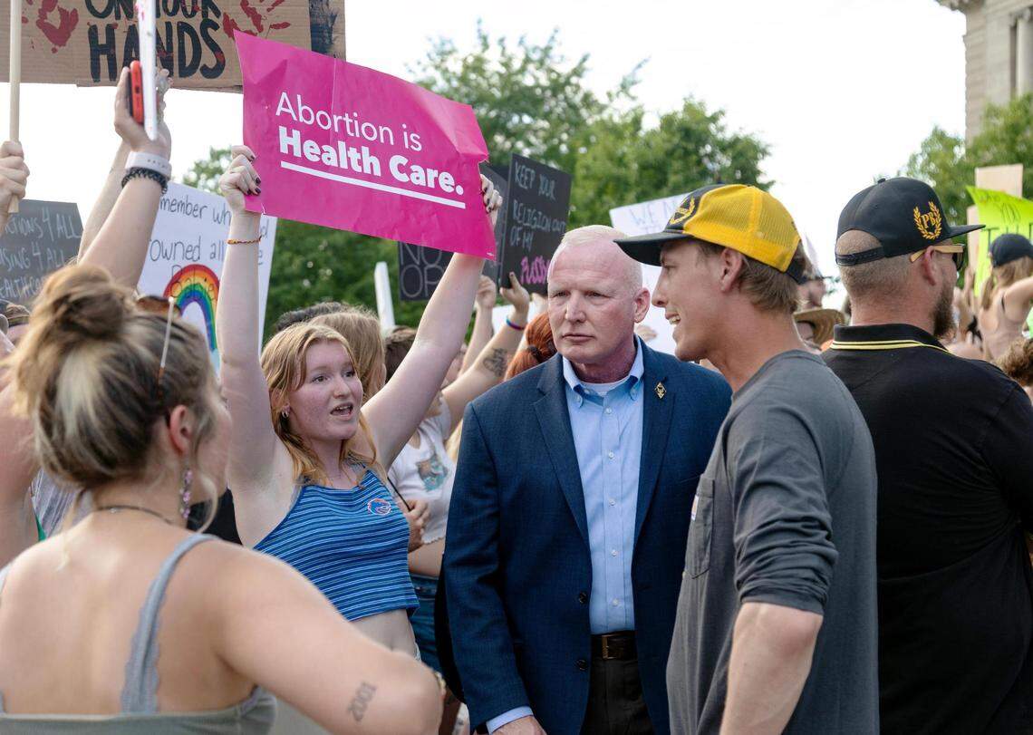 Lt. Michael Kish, in a blue blazer, stands between abortion-rights protesters and counterprotesters outside the Idaho Capitol in 2022.
