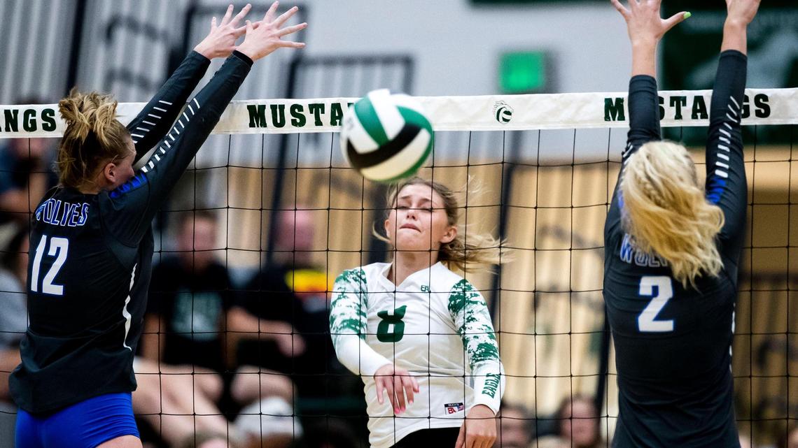 Eagle senior Madi Hauskins splits Timberline blockers Piper Davis (12) and Courtney Cline for a point during a 5A SIC volleyball match Tuesday at Eagle High School.