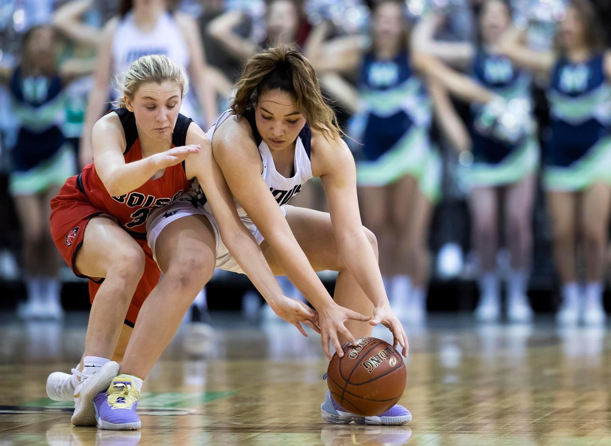 Mountain View guard Trinity Slocum and Boise’s Allison Ross rush to a loose ball during the first round of the 5A state girls basketball tournament Thursday, Feb. 20, 2020 at Ford Idaho Center in Nampa.