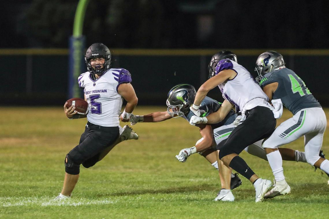 Rocky Mountain quarterback Kobe Warr evades Mountain View’s rush Friday, Sept. 1, 2020 at Mountain View High School in Meridian.