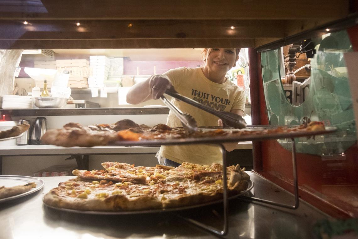 Kelsey Nelson serves up lunch slices at Messenger Pizza, an anchor business in downtown Nampa.