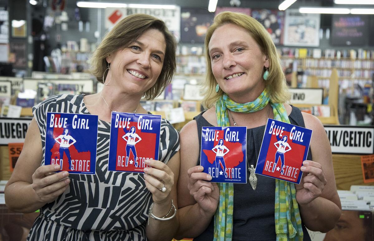 Polly Breneman, left, came up with the idea and former sister-in-law Jessica Evett designed their famous “Blue Girl, Red State” stickers first for Idaho, then Texas and Utah. Colorado stickers had been available, but that state is skewing purple - which is good, according the pair. “We’re hoping to put ourselves out of business,” says Breneman, politically speaking.