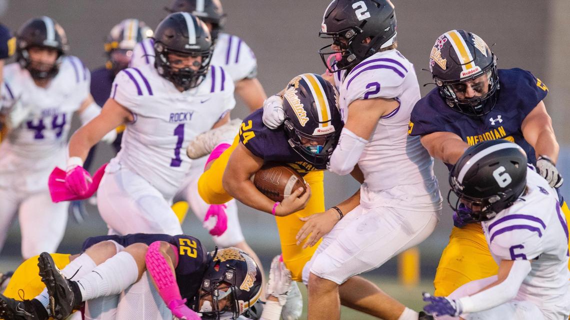 Meridian running back Luke St. Michell is stopped by Rocky Mountain’s Art Williams in the first quarter Friday at Meridian.