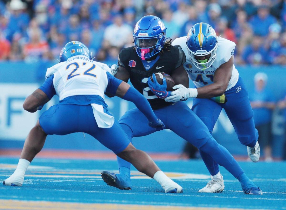 Boise State running back Ashton Jeanty fights off a tackle attempt by San Jose State safety Tre Jenkins and San Jose State linebacker Taniela Latu during the game against San Jose State at Albertsons Stadium. SJS leads BSU 28-14 at the half. Saturday October, 07, 2023.
