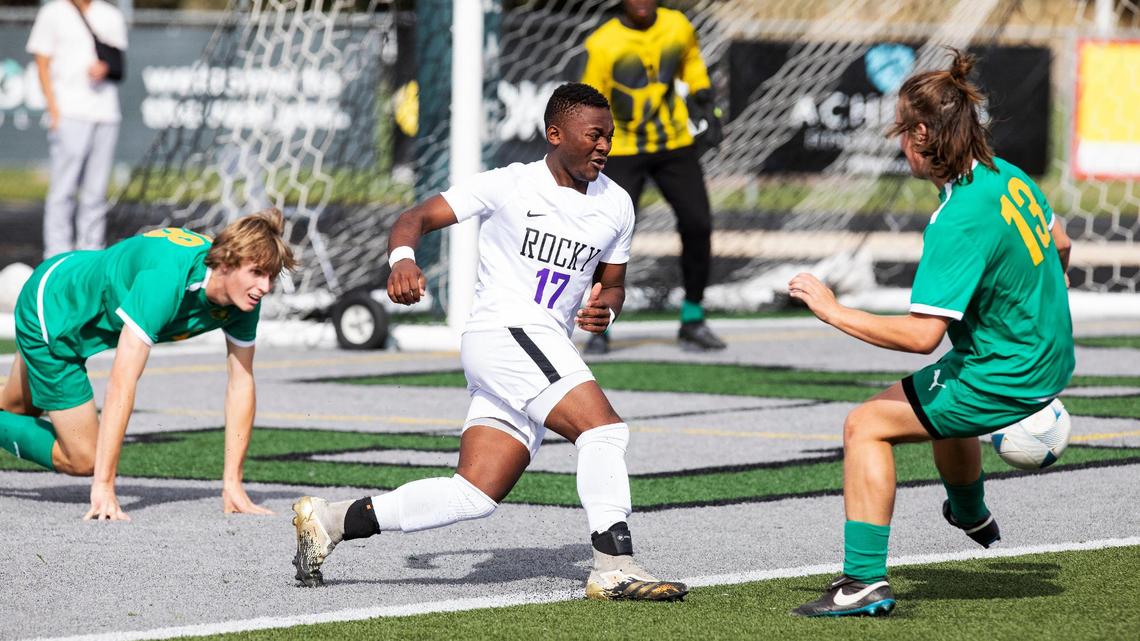 Rocky Mountain’s Lieven Ivanza scrambles toward the ball between a pair of Borah defenders Friday in their 5A state tournament game at Eagle High School. The Grizzlies eked out a 1-0 win to advance to the semifinals.