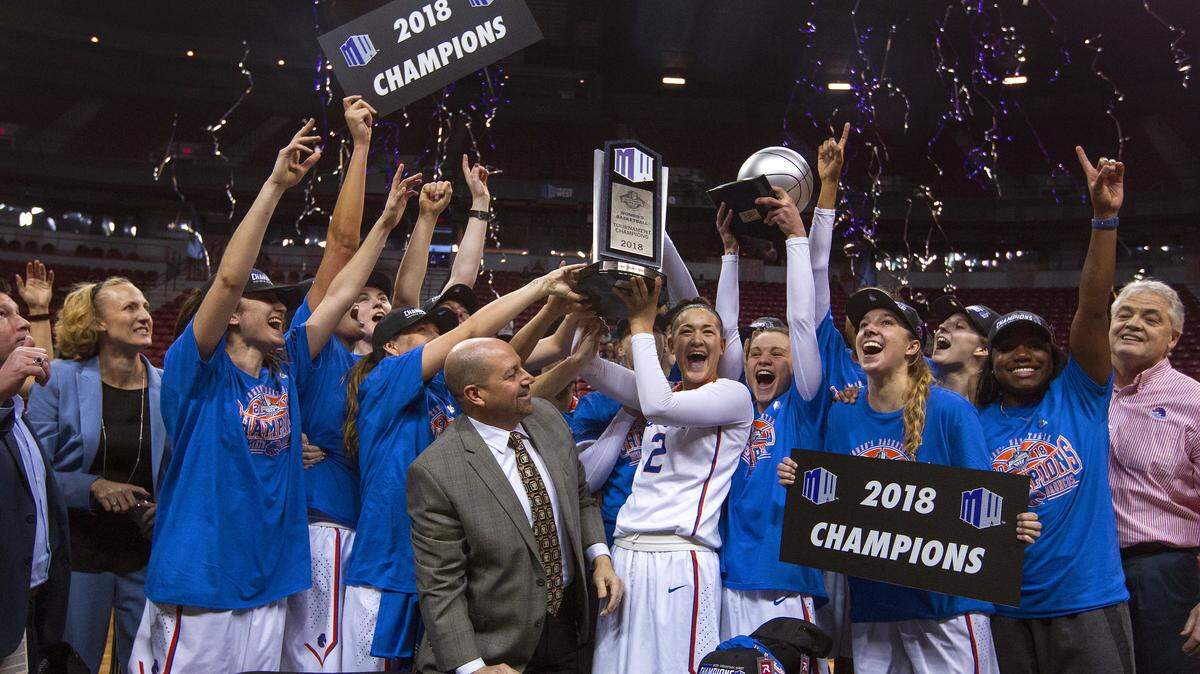Boise State celebrates with the trophy after its 62-60 win over Nevada in the Mountain West Tournament championship game on March 9, 2018, in Las Vegas.