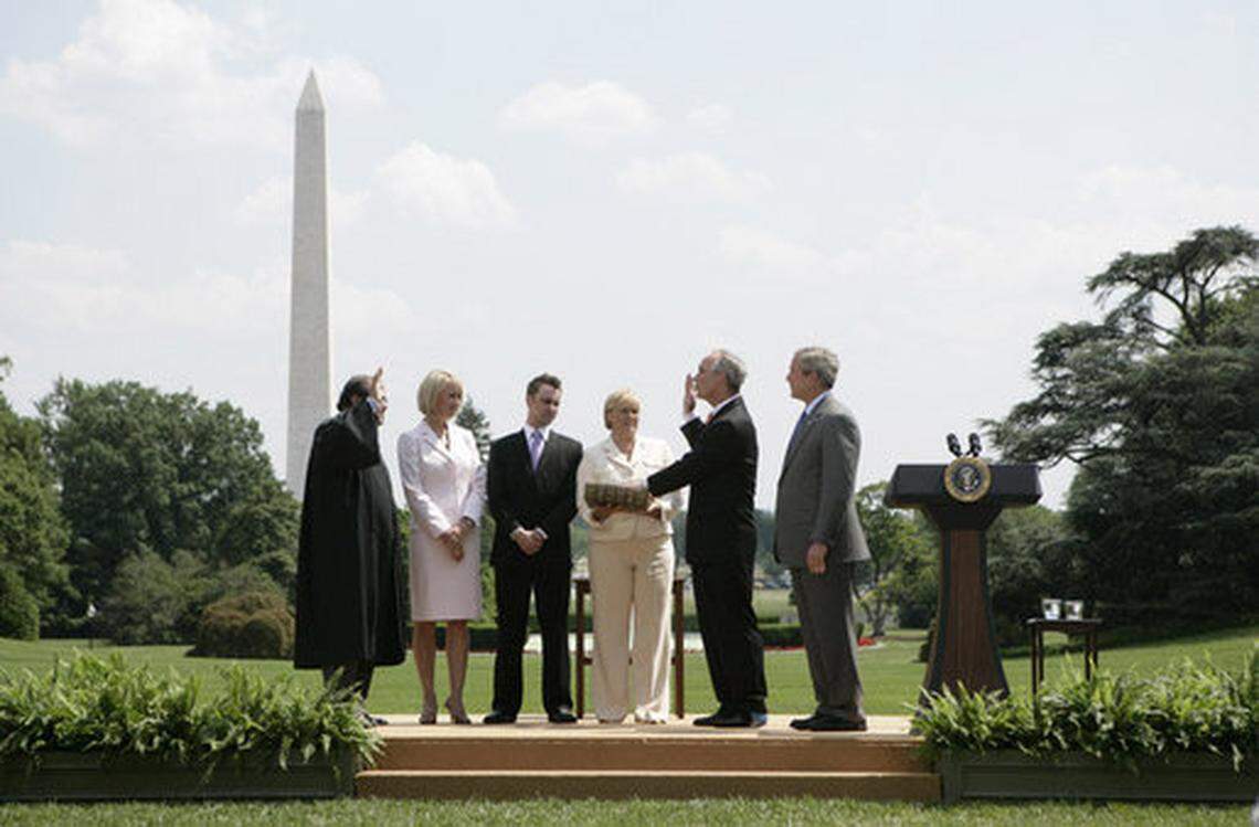 President George W. Bush, right, stands with former Idaho Gov. Dirk Kempthorne as he is sworn-in as U.S. secretary of the interior by Supreme Court Justice Antonin Scalia, left, on June 7, 2006, on the South Lawn of the White House in Washington, D.C. Patricia Kempthorne holds the Bible during her husband’s swearing-in, joined by their children, daughter Heather Kempthorne Myklegard and son Jeff Kempthorne.