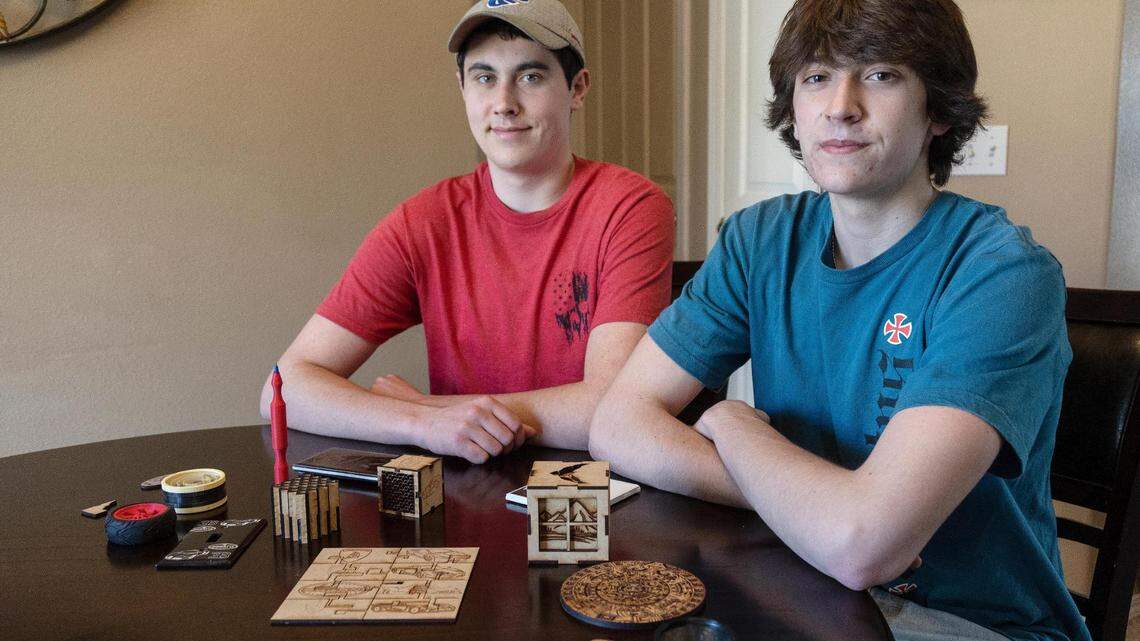 Capital High School 2021 graduate Michael Dykstra, left, and his brother, sophomore Alex Dykstra, each hold a project they made in the school’s engineering class. The Dykstra family is upset that the Boise School District is moving its engineering classes off the campuses of four high schools over to the Dennis Technical Education Center.
