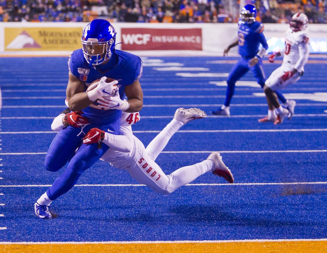 Boise State running back Andrew Van Buren breaks a tackle attempt by New Mexico linebacker Brandon Shook and scores a touchdown in the third quarter Saturday at Albertsons Stadium.