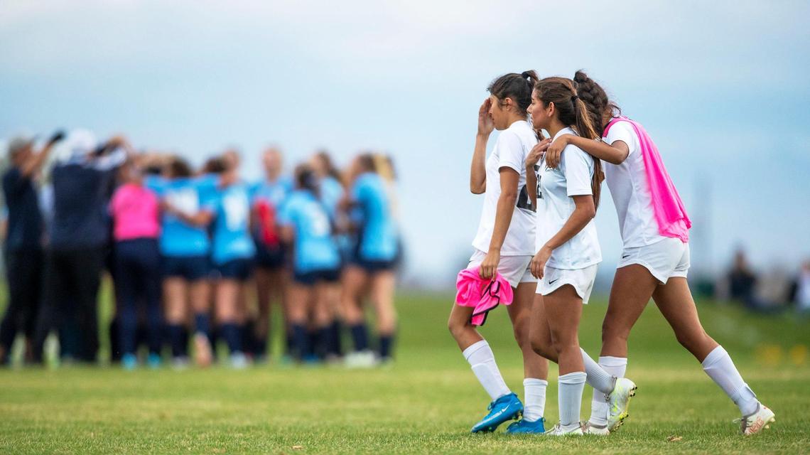 Vallivue teammates walk off the pitch after a 3-0 loss to Twin Falls in the 4A girls soccer state championship Saturday.