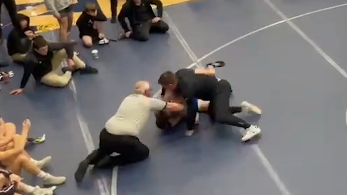 A screenshot from a Jan. 20 video shows Rocky Mountain assistant wrestling coach Russell Brunson hitting a student from Nyssa, Oregon, during the Skyview Duals. Brunson has since been banned for life from coaching any Idaho high school sport.