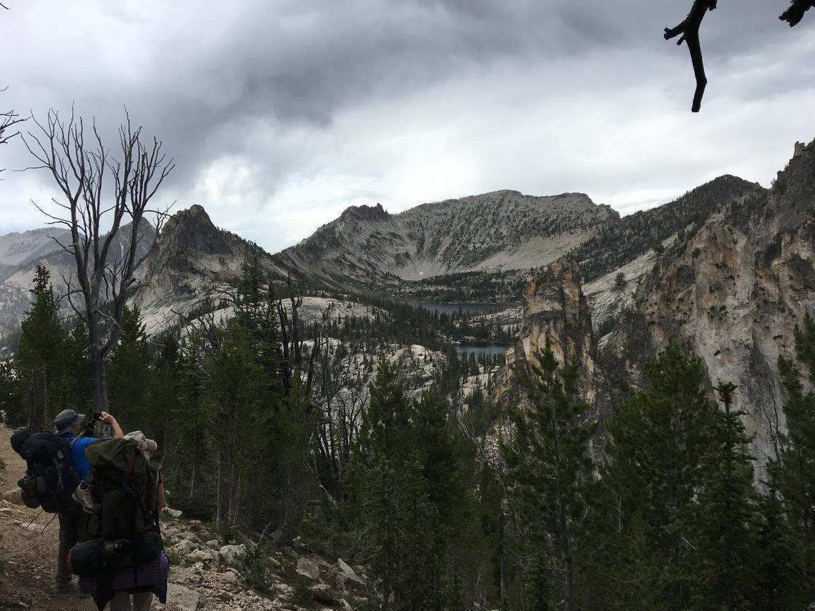 A pair of backpackers stop to take some photos of Harbor and Wilson lakes in the Bighorn Crags. Although the views are beautiful, the hike into Wilson Lake is challenging, with a 600-foot elevation gain in less than a mile.