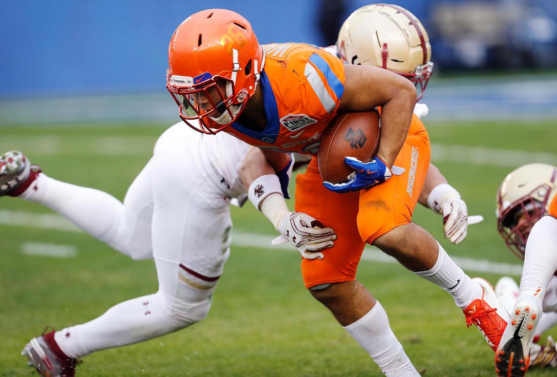 Boise State’s Avery Williams slips by Boston College’s Max Richardson while returning a punt during the SERVPRO First Responder Bowl on Wednesday in Dallas.