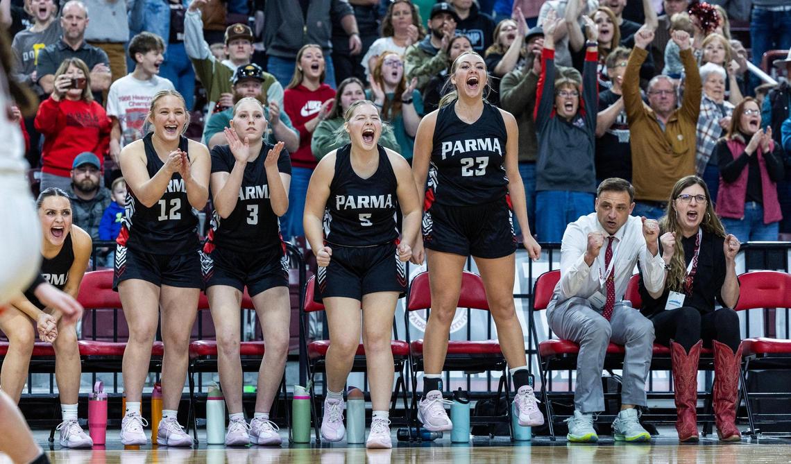 Parma’s bench cheers teammate Kaidance Kaiser after she hit two free throws with 8.1 seconds left to seal the 3A state title victory Saturday.