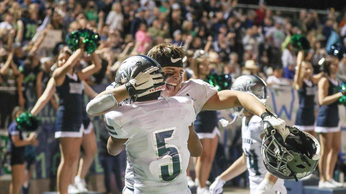 Mountain View’s Luis Ponce (5) and Jackson Beck celebrate a hard fought 26-20 win over rival Rocky Mountain on Friday at Rocky Mountain High School in Meridian.