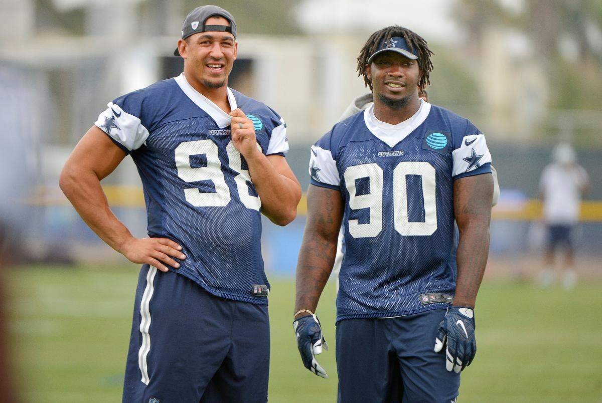 Dallas Cowboys defensive tackle Tyrone Crawford (98) and defensive end Demarcus Lawrence (90) talk during a walk-through at Cowboys training camp in Oxnard, Calif., on Aug. 9, 2016.