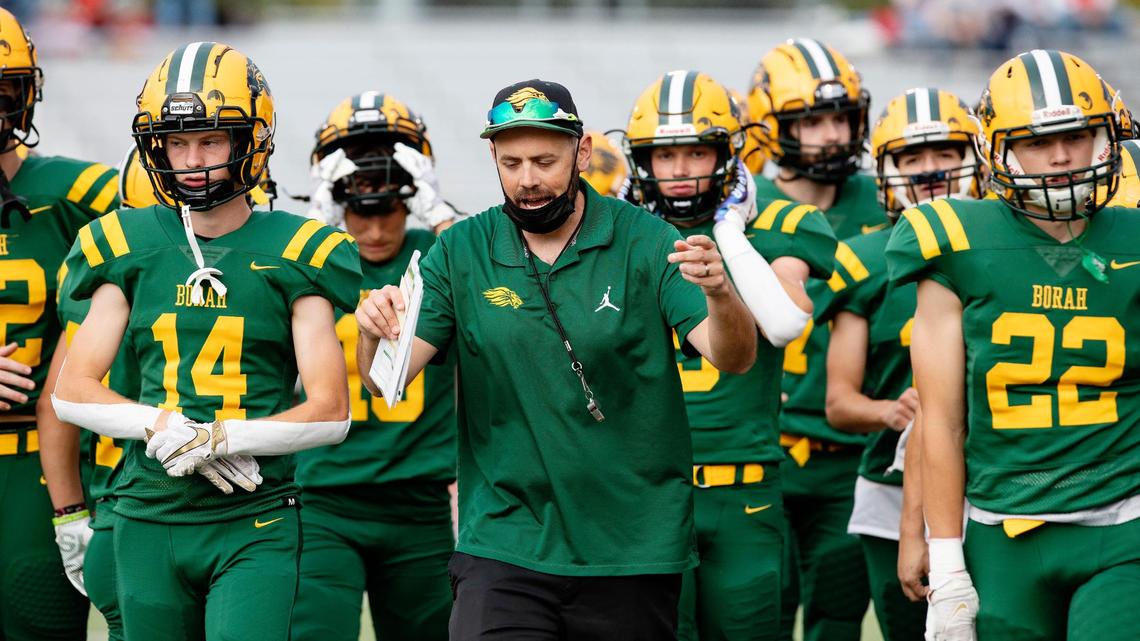 Borah head football coach J.Q. Kenyon leads the Lions in pregame warmups Thursday at Dona Larsen Park. The Lions beat Owyhee 28-21 four days after assistant coach Quane Kenyon, J.Q.’s father, died suddenly.