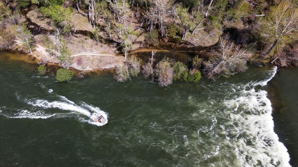 A Boise Fire Dive Rescue boat searches below the diversion dam below Barber Park where a kayaker was reported missing on the Boise River, Monday, May 1, 2023.