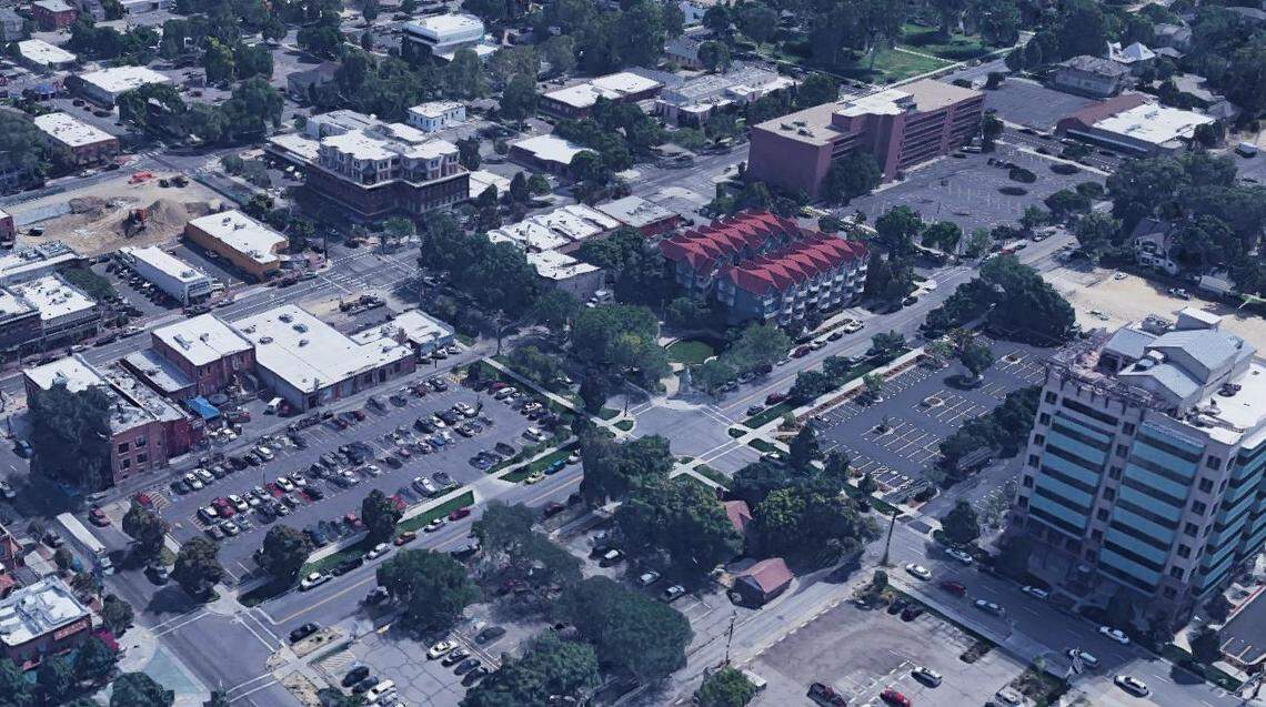 The so-called Old Boise Blocks on Grove Street run from 6th Street, in the bottom left, east to 3rd Street, upper right. The blocks are dominated by surface parking lots. C.W. Moore Park is in the center of this Google Earth image, with the C.W. Moore Apartments just beyond the park and the C.W. Moore Plaza office building at lower right. The Basque Block on 6th is out of the image to the lower left. The heart of the Old Boise historic commercial district is on Main Street to the north.