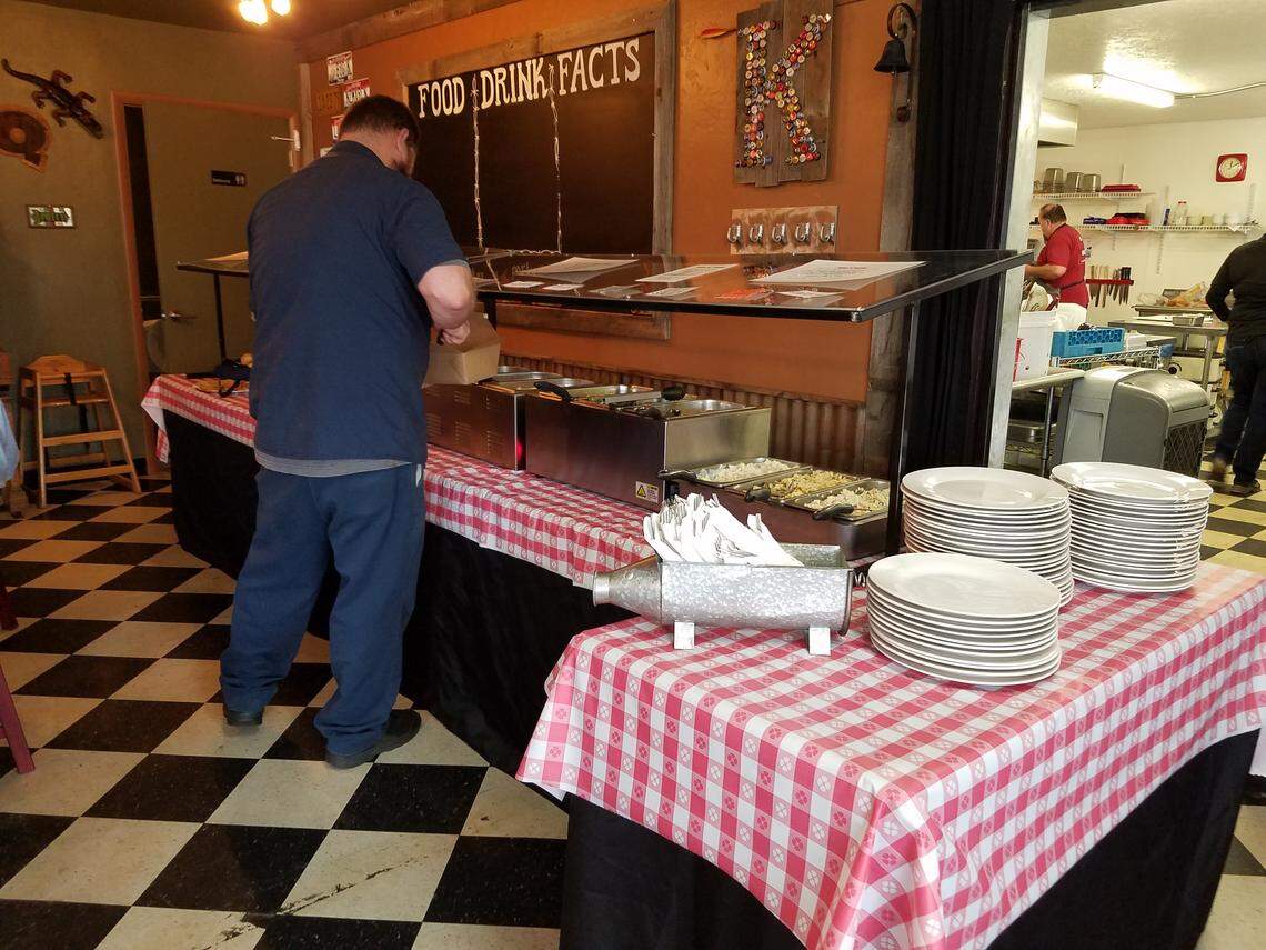 A customer loads up at the BBQ lunch buffet at Big K.