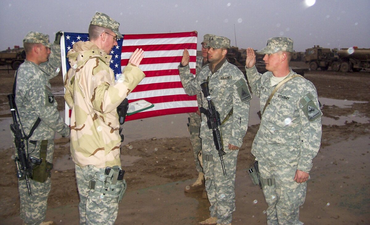 Jared Hatch, far right, took an oath of re-enlistment in SinJar, Iraq, in February 2006. “I re-enlisted for 5 years,” he said. “It was much nicer and wetter up north.”