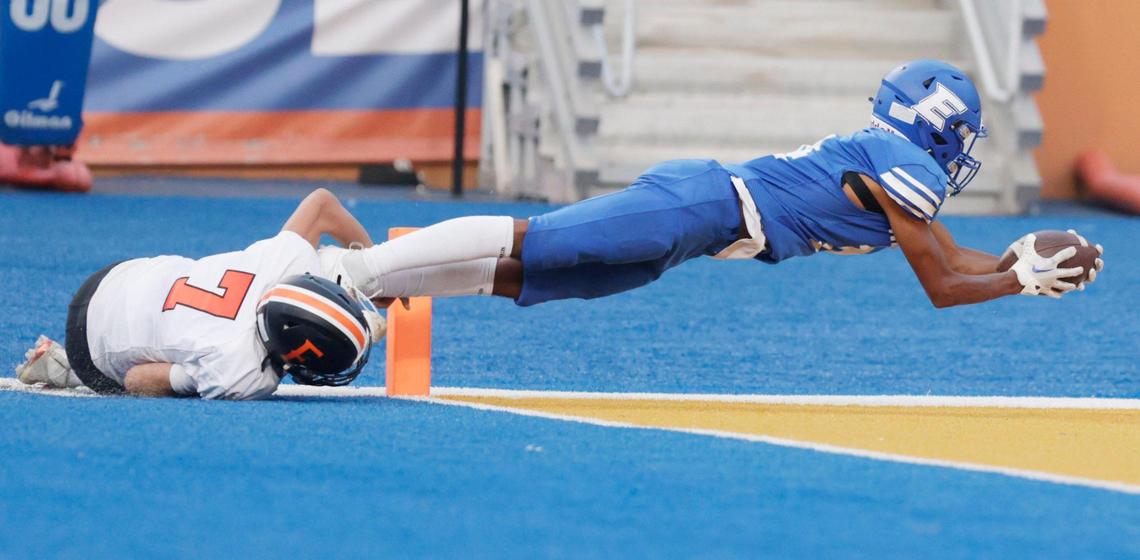 Emmett linebacker Dawson Conklin fights off a tackle by Fruitland’s Austin Tesnohlidek and dives across the goal line four a touchdown Sept. 1 at Albertsons Stadium. The Huskies want to drop down a classification in all team sports except baseball and softball.