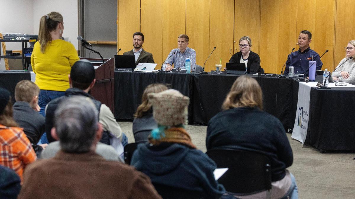 The Meridian Library District Board of Trustees, including Chair Jeff Kohler, blue shirt, listen to public comment during a board meeting in February. The board considered a request for reconsideration of a children’s book with LGBTQ+ themes and voted unanimously to keep the book in the library collection.