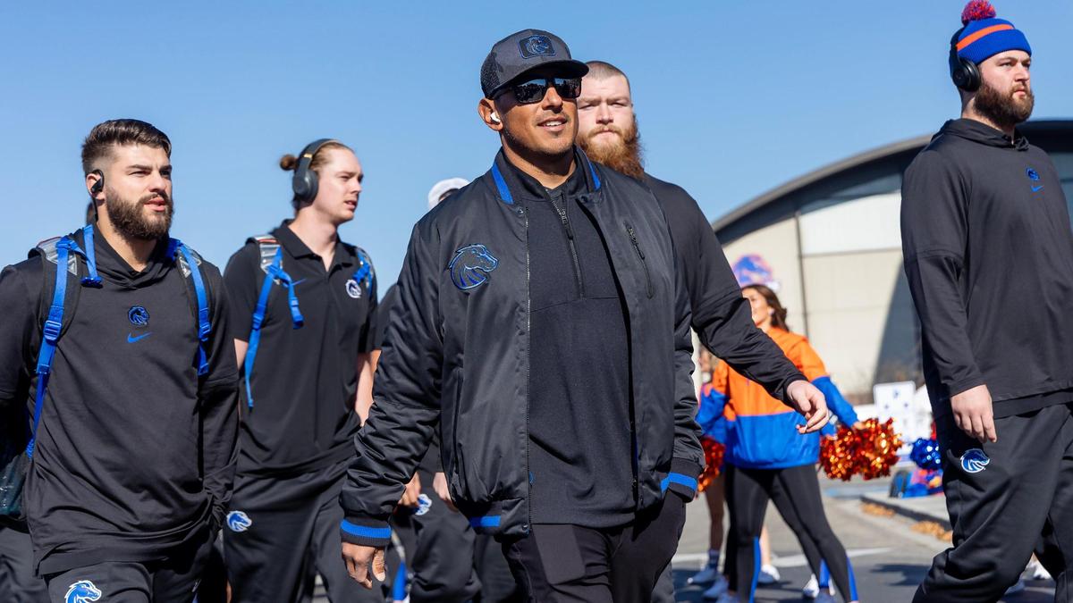 The Boise State University football team including coach Andy Avalos, center, walks into Albertsons Stadium for the game against Wyoming, Saturday, Oct. 28, 2023.