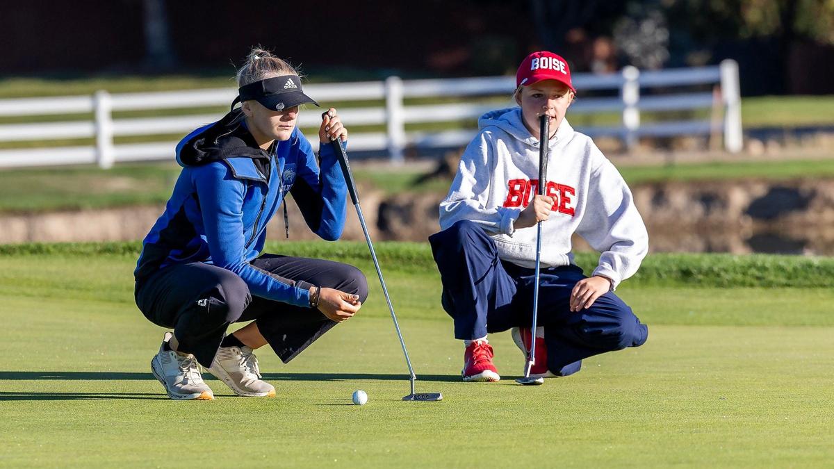 Timberline’s Ella Arnzen, left, and Boise’s Alli Churchman line up their putts Tuesday during the 6A District Three Girls Golf Tournament at the Boise Ranch Golf Course. Arnzen captured in the individual title by nine strokes by shooting a 3-under 68.
