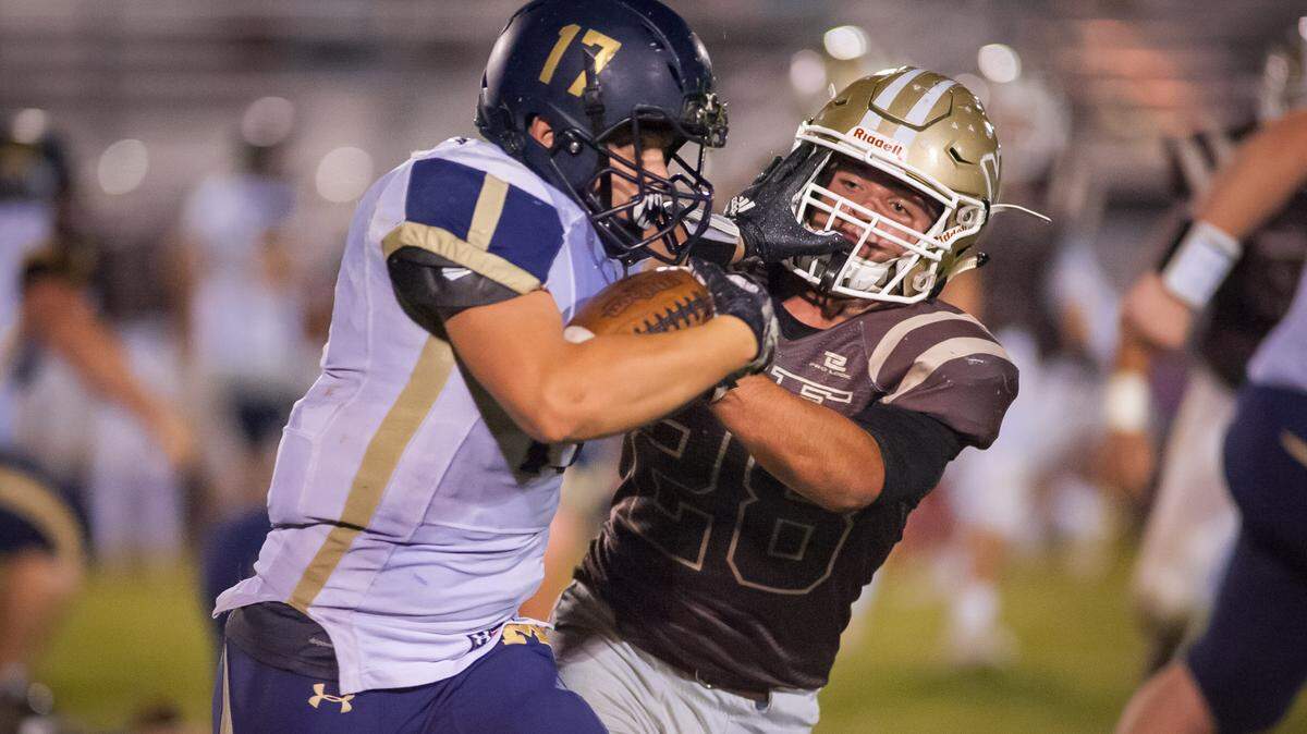 Middleton’s Jake Tuckett stiff-arms Vallivue’s Carson Child in the second half of Friday night’s 4A SIC thriller in Caldwell, won by the Vikings in overtime. Tuckett rushed for 144 yards and two touchdowns.