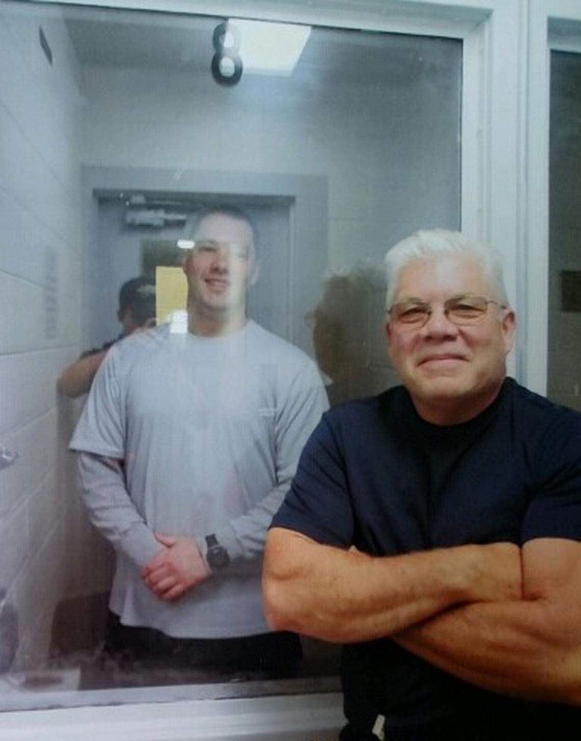 Bob Templin visits his son, Bobby Templin, through a glass panel at the Idaho Maximum Security Institution in Kuna.