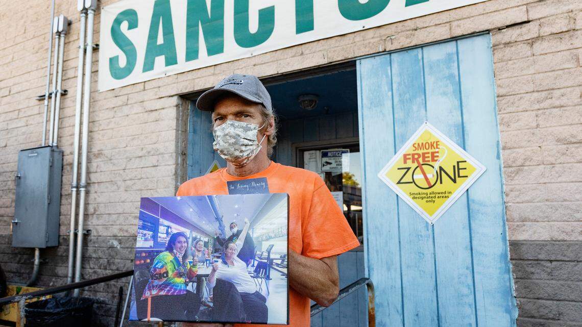 Interfaith Sanctuary resident Kevin Bullard holds a photograph of Debi Davis, a resident of the shelter who died from COVID-19. Five unhoused people in Boise have died from the disease so far.